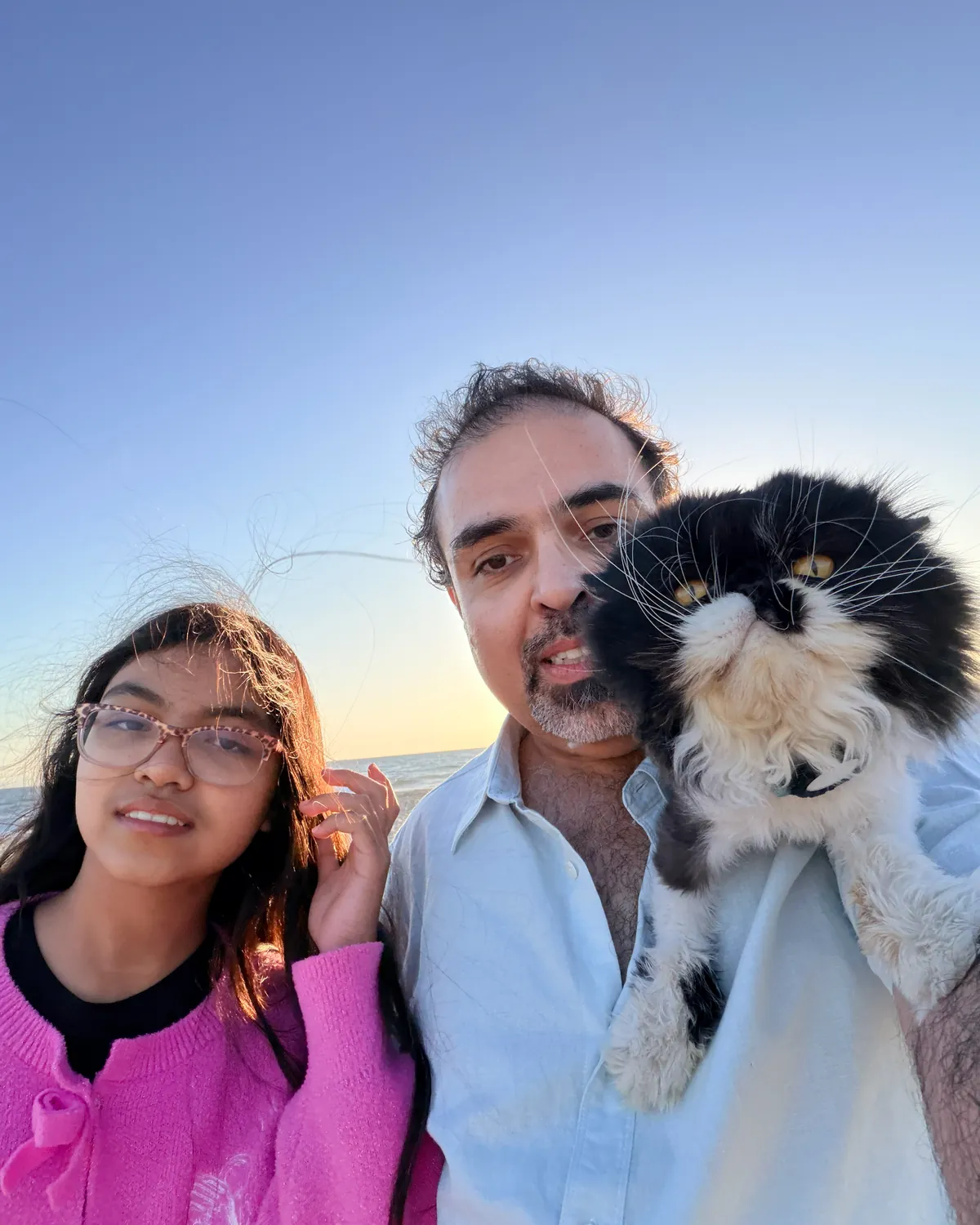 Sassan Darian with his family on the beach at golden hour
